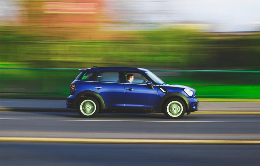 A blue car driving fast