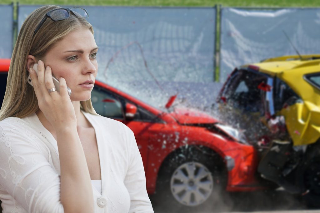 A worried blonde woman calls for help at the scene of a vehicle collision