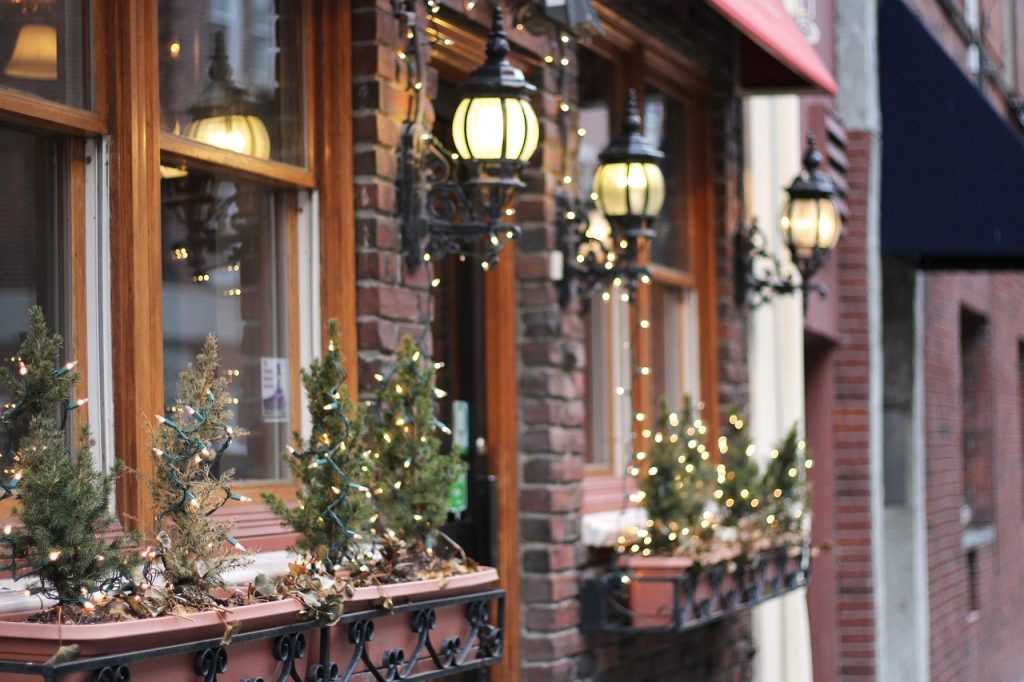 A close up shot of Victorian townhouses decorated with Christmas lights. 